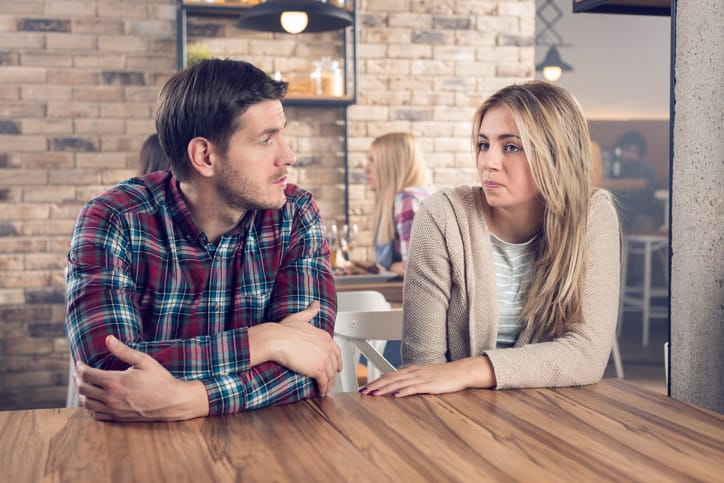 Young couple having a serious conversation in a bar.