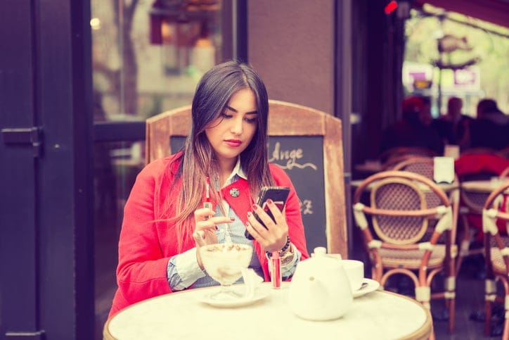 brunette texting red coat