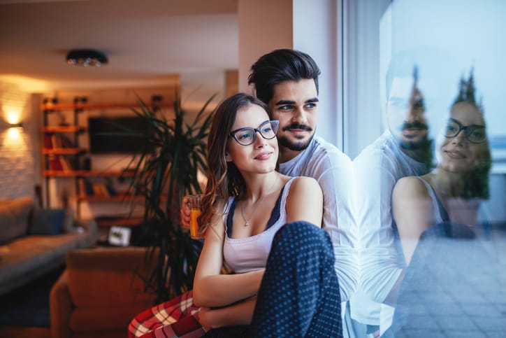 Smiling young couple bonding at home.