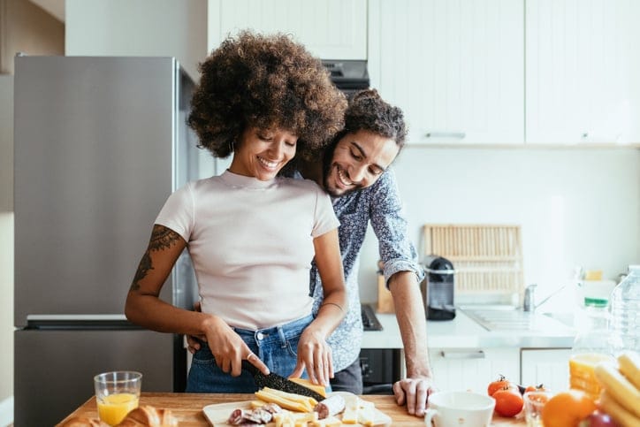 Happy couple cooking in the kitchen.
