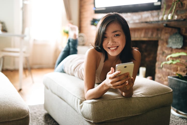 woman using the phone in the living room