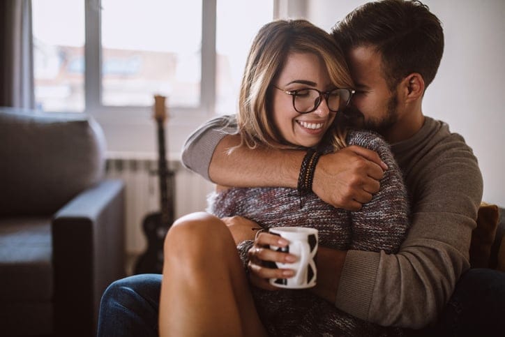 Young couple cuddle