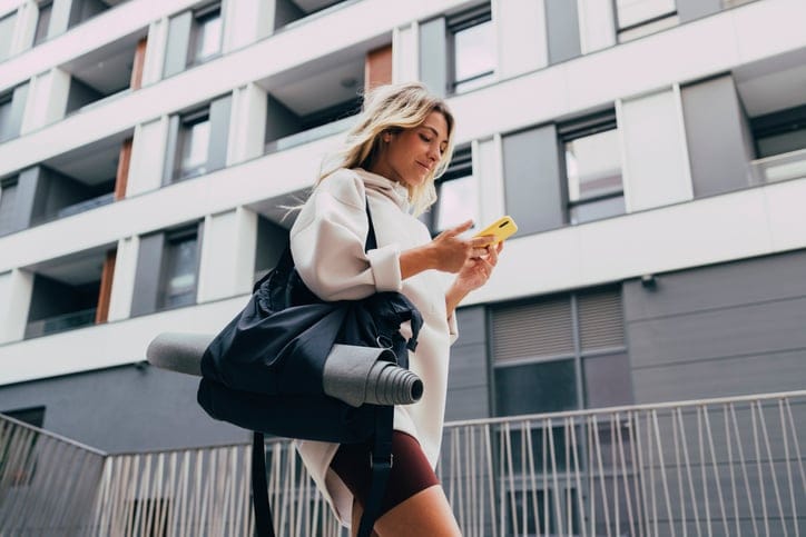blonde woman texting after yoga