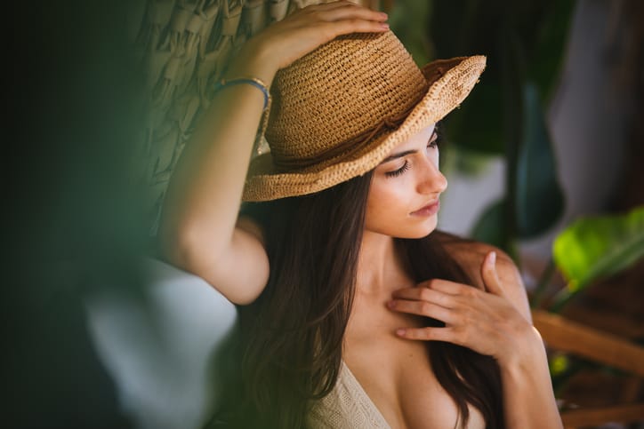 Female tourist relaxing at luxurious hotel resort.