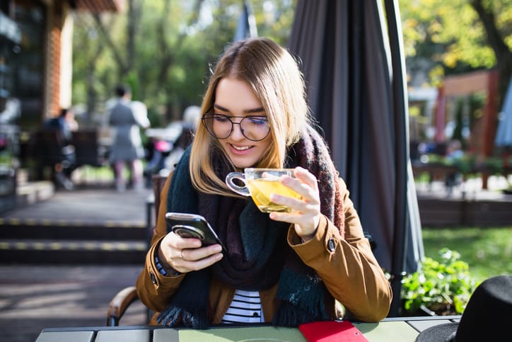 Beautiful young woman enjoying in cafeteria and drinking tea.