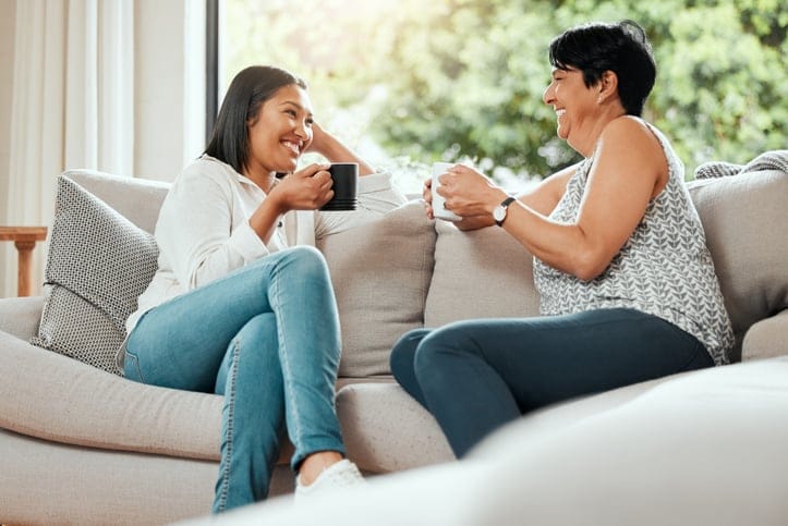 woman chatting with mom on couch