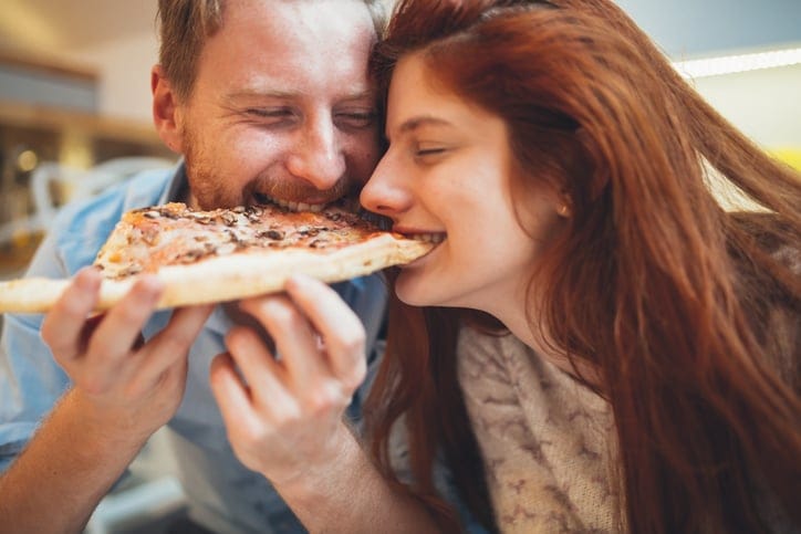 young couple sharing pizze