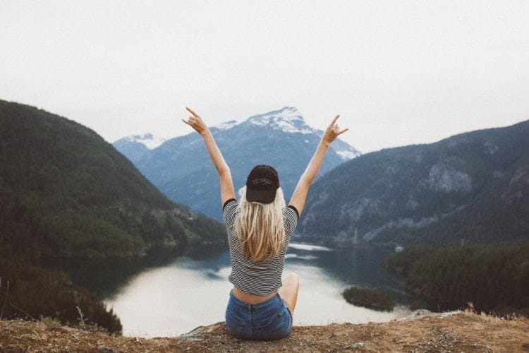 girl hands in the air mountain