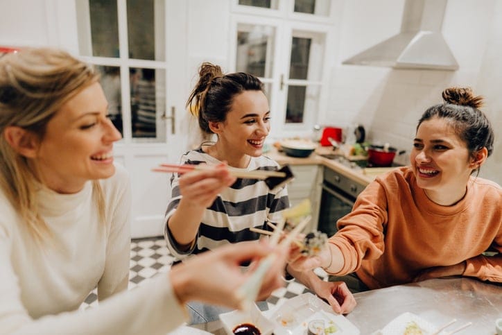 female friends eating chinese takeout at home