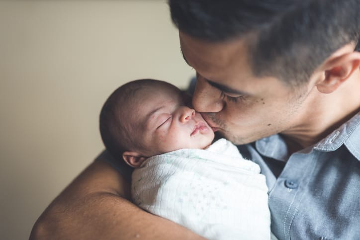 New Dad Holding Infant Daughter