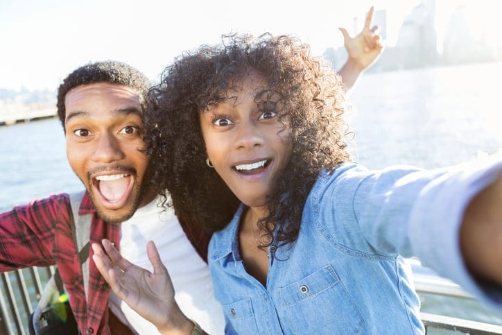 Playful couple take selfie on vacation
