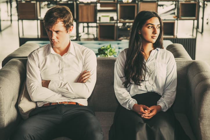 Resentful colleagues looking away from each other because of misunderstanding. Unhappy business people being
