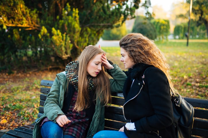 woman consoling her friend
