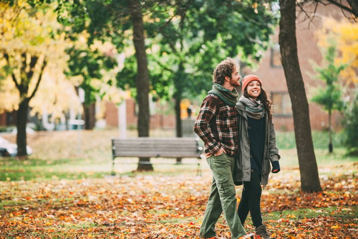 young couple strolling through the park