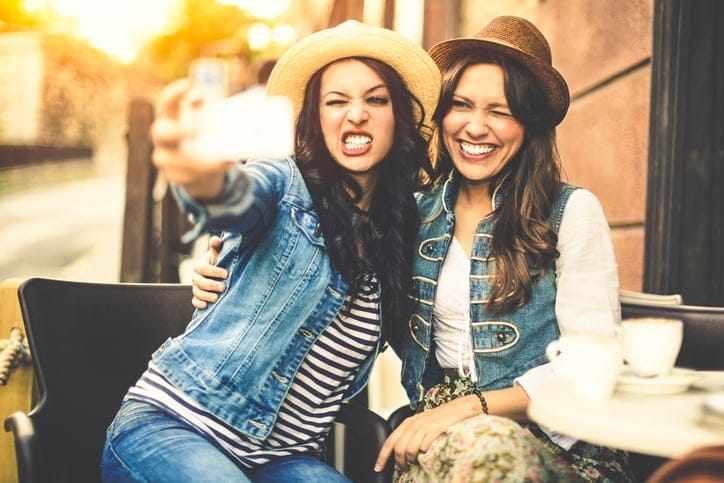 Women talking selfies to post.