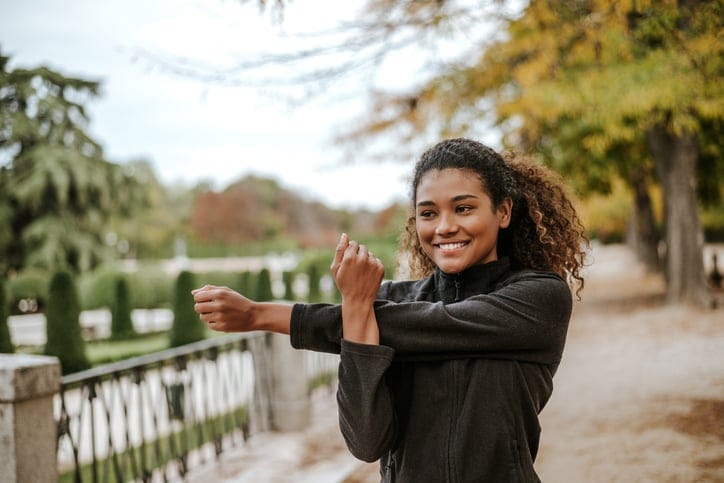 A woman stretching before she starts her exercise