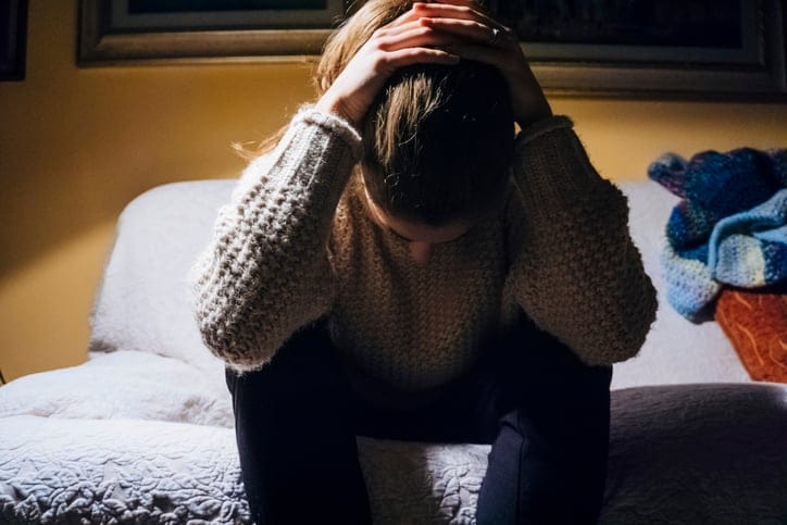 Young female adult hands on head feeling frustrated.
