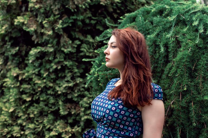Plump girl on a botanical spring walk