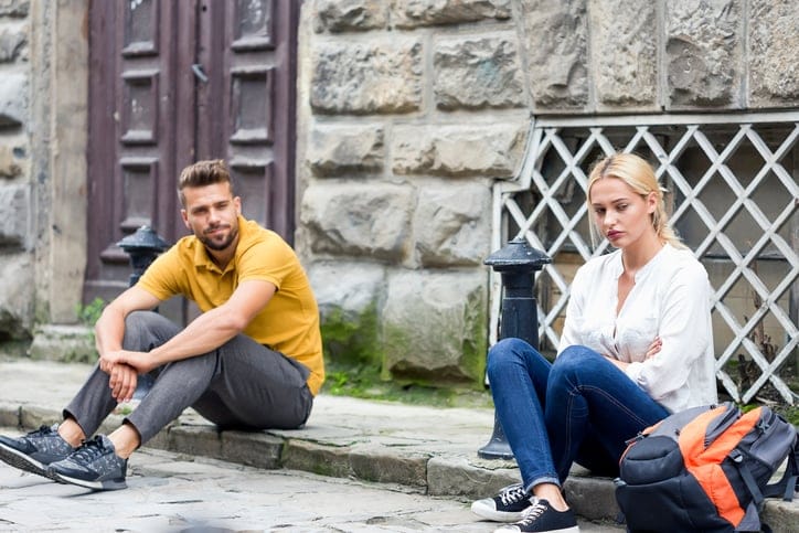 young couple aruging in the street