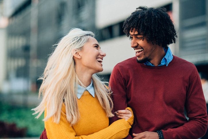 Happy mixed race couple have fun outdoor