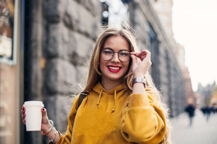 blonde woman glasses smiling