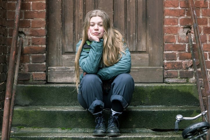 Sad looking young woman sitting.