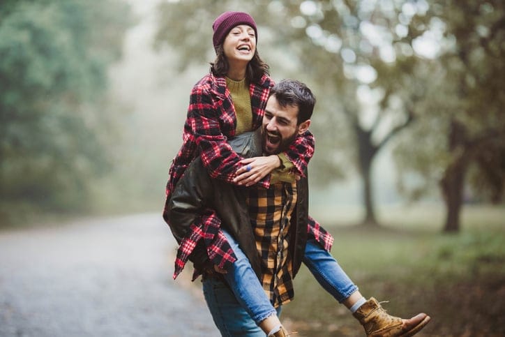 boyfriend giving girlfriend piggyback ride