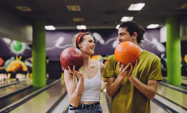 young couple on a date bowling