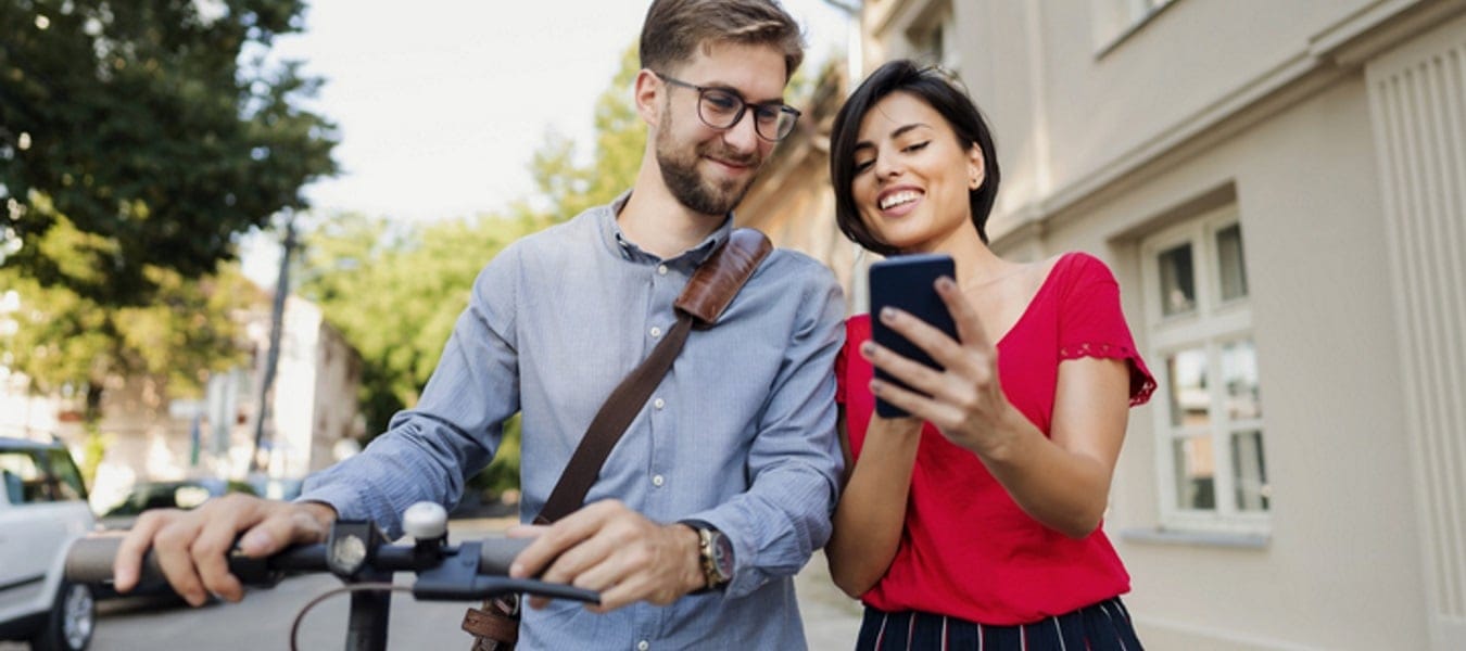 Couple looking together at phone.
