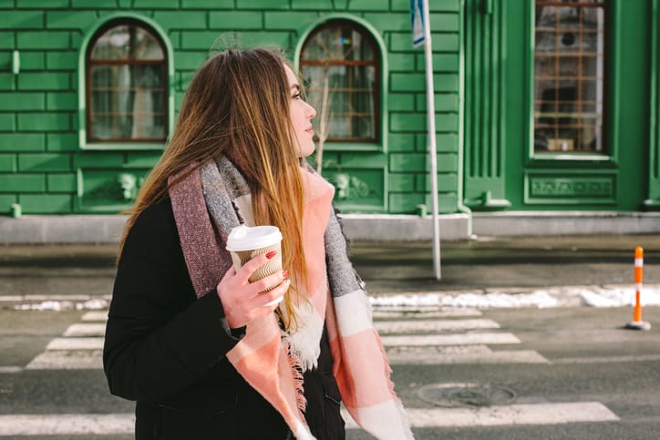 woman drinking coffee outside