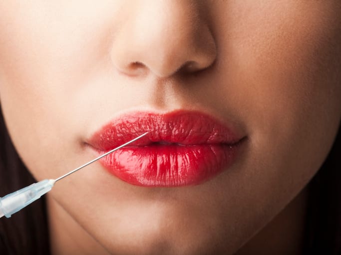 Anti-aging pic of woman getting botox or her lips plumped.