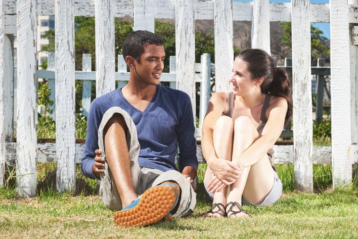 Young couple sitting together at a garden