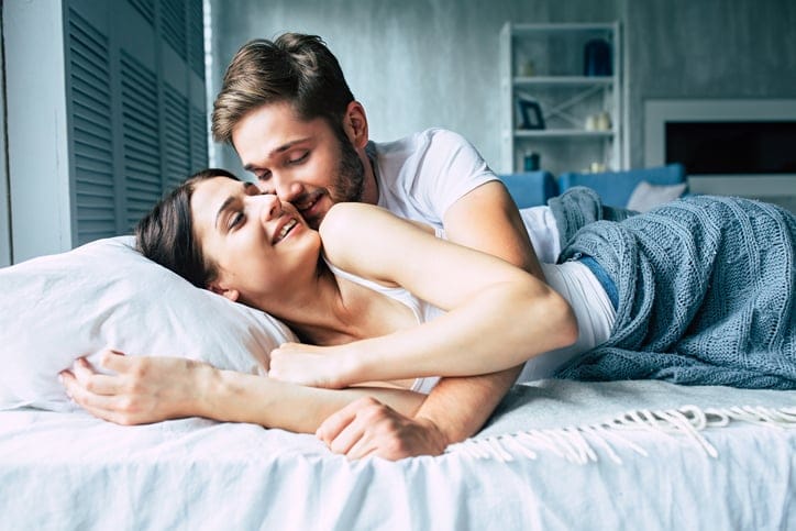 playful couple on the bed