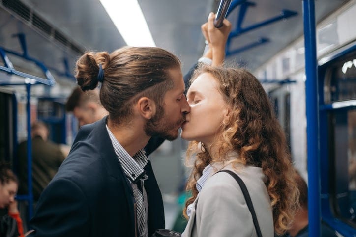 couple kissing on metro train