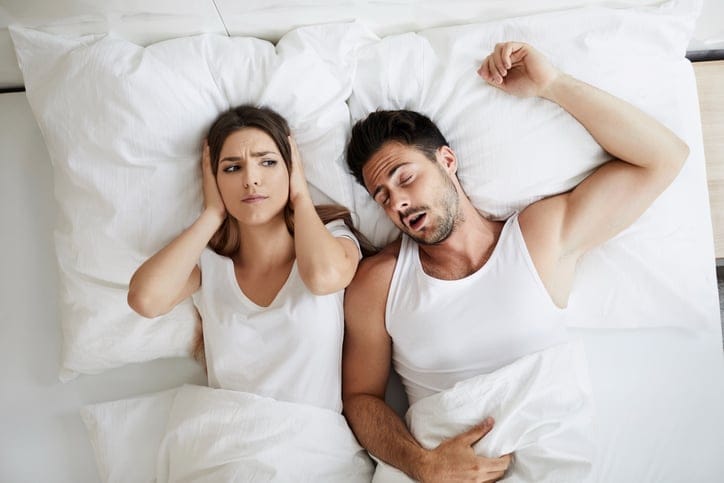 Woman sleeping with a snorer.