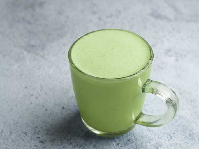 Matcha green tea latte in glass cup.
