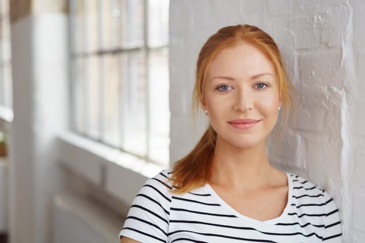 red headed woman in striped t-shirt