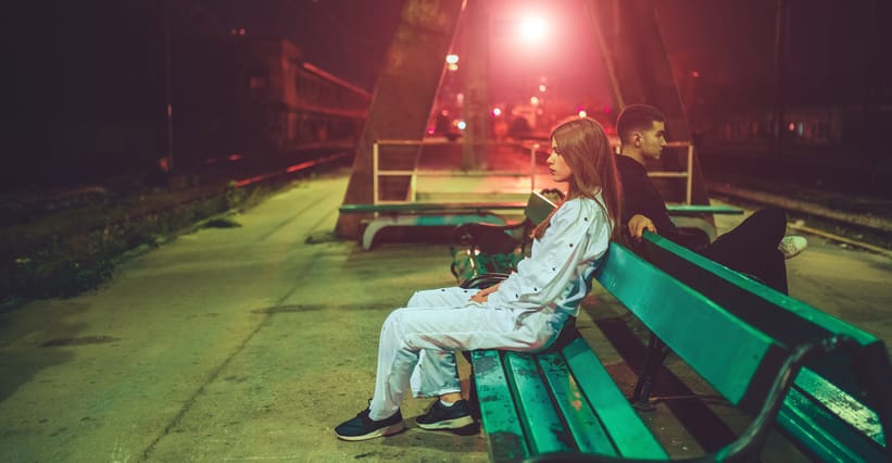 woman sitting on a bench at night
