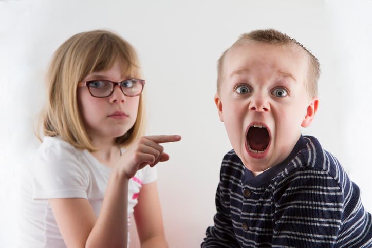 Boy got caught and now is in trouble and making a funny face.