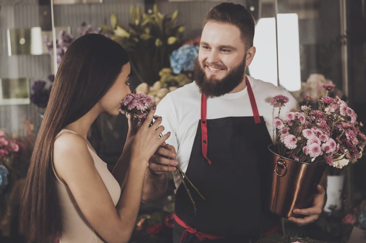 man giving a woman flowers