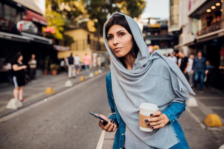 muslim girl standing in the street