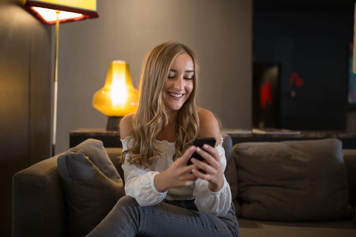 woman sitting at home texting