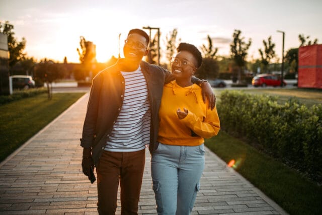 happy couple taking sunset walk