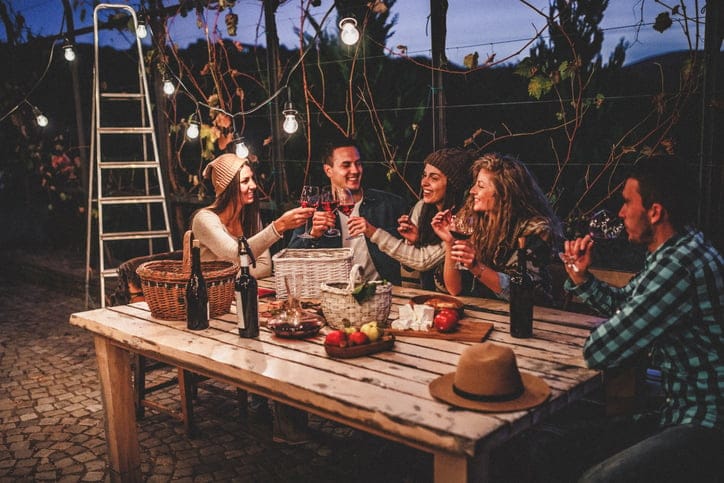 friends sitting aorund a wooden table