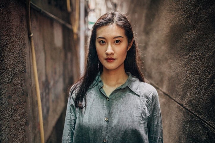 long haired asian woman facing camera
