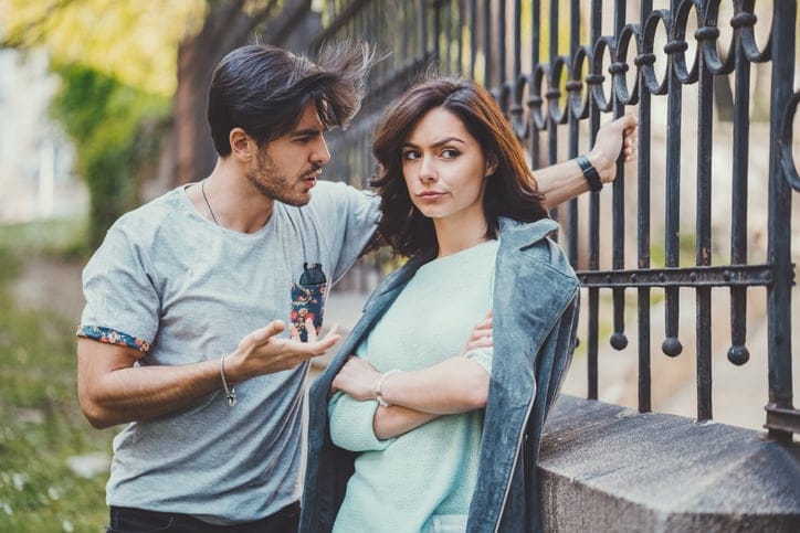couple arguing outside railings