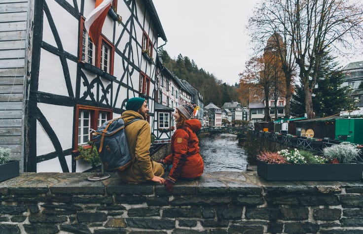 couple sitting on a wall on vacation