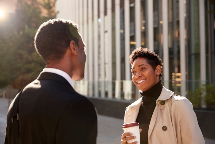 two african americans chatting in the street