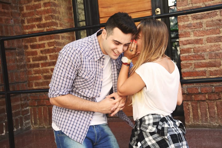 couple whispering to each other