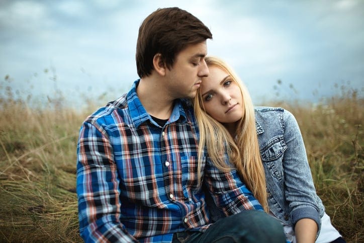 couple in the field hugging
